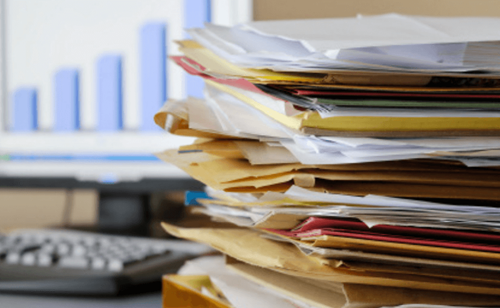 Pile of folders on a desk
